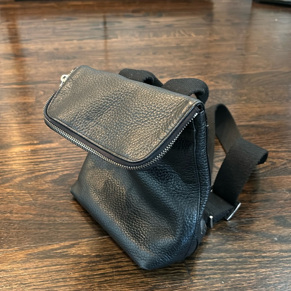 Whistles, black, leather pebbled, small backpack.